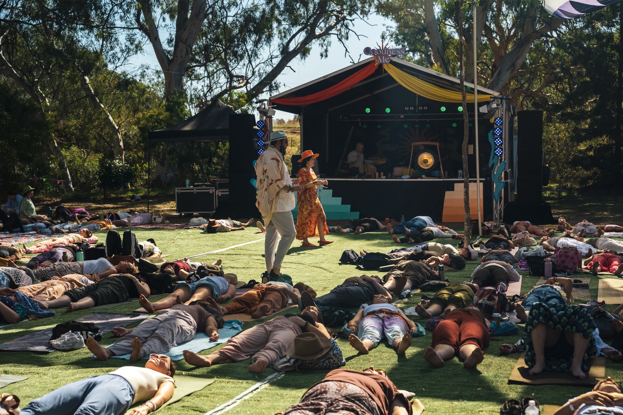 A large community breathing together at an outdoor festival