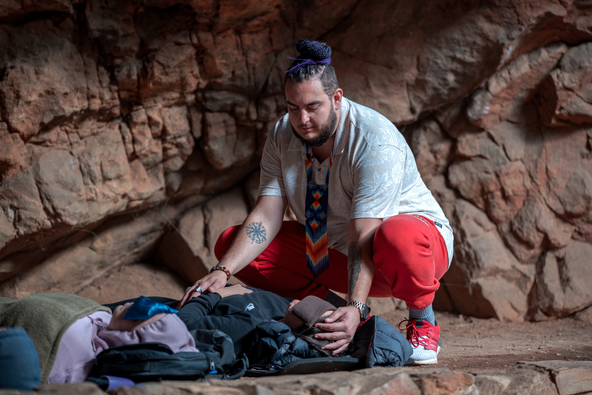 A facilitator offering grounded support during group breathwork